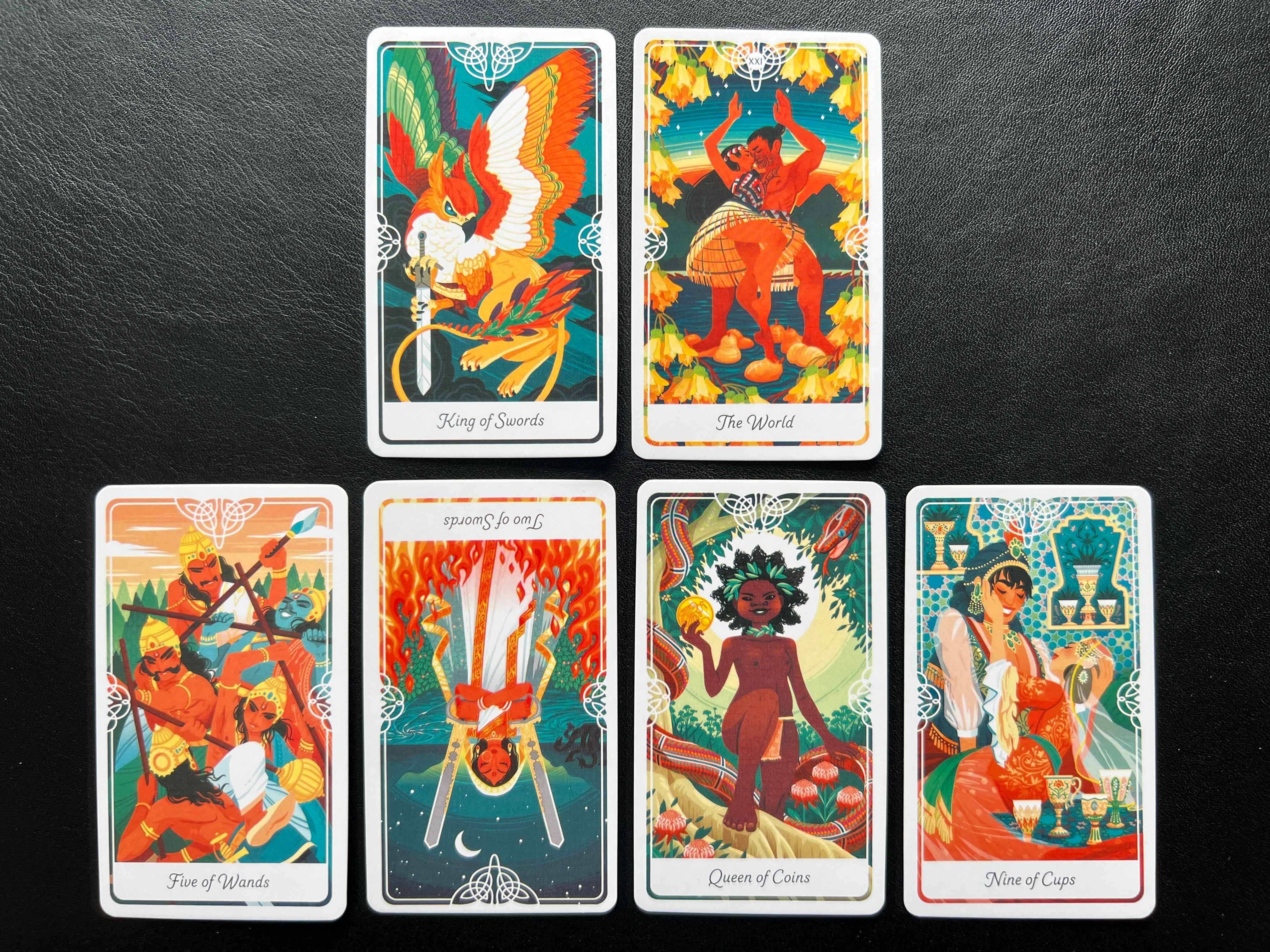 King of Swords plus The World cards, Five of Wands, Two of Swrods reversed, Queen of Coins, Nine of Cups