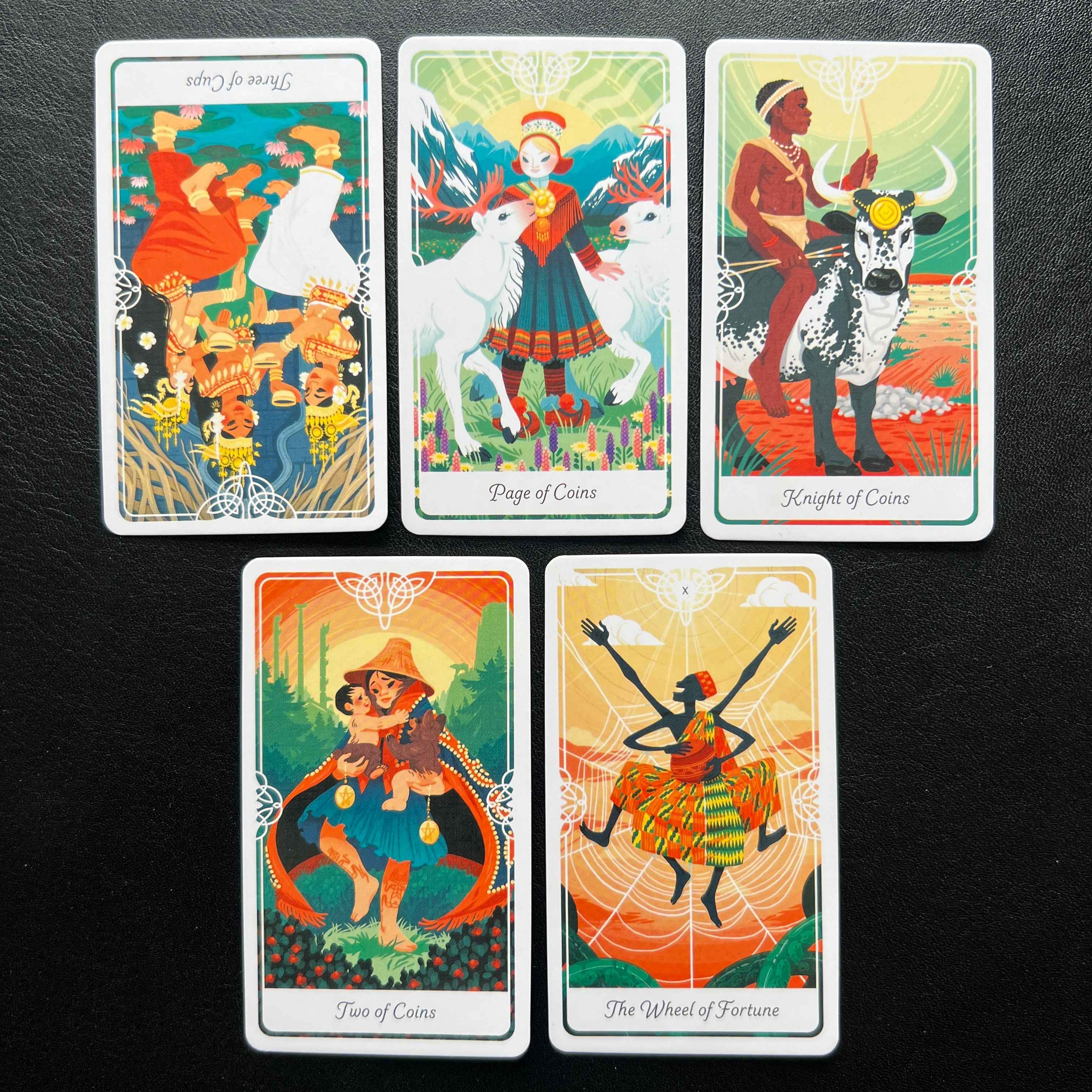 Page of Coins, Three of Cups reversed, Knight of Coins, Two of Coins, The Wheel of Fortune